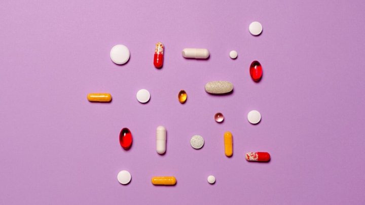 medication pills isolated on purple background