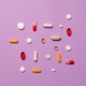 medication pills isolated on purple background
